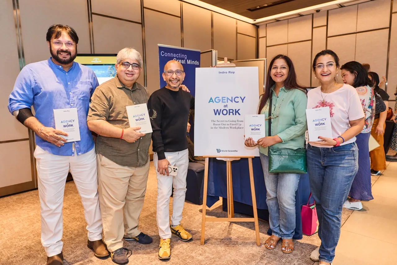 Indro Roy signing copies of Agency at Work